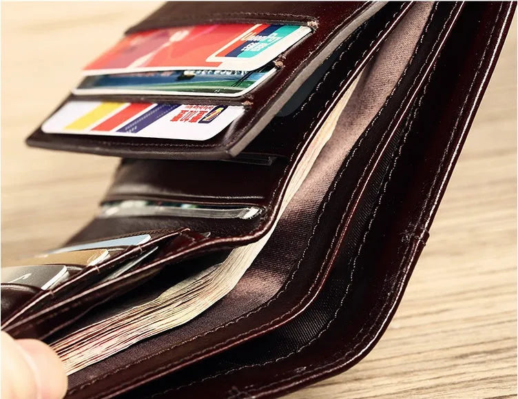 Men's leather wallet open showing card slots, coin pocket, photo window, and document holder in black or brown