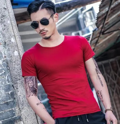 Man wearing a lightweight short sleeve summer T-shirt in a solid colour.