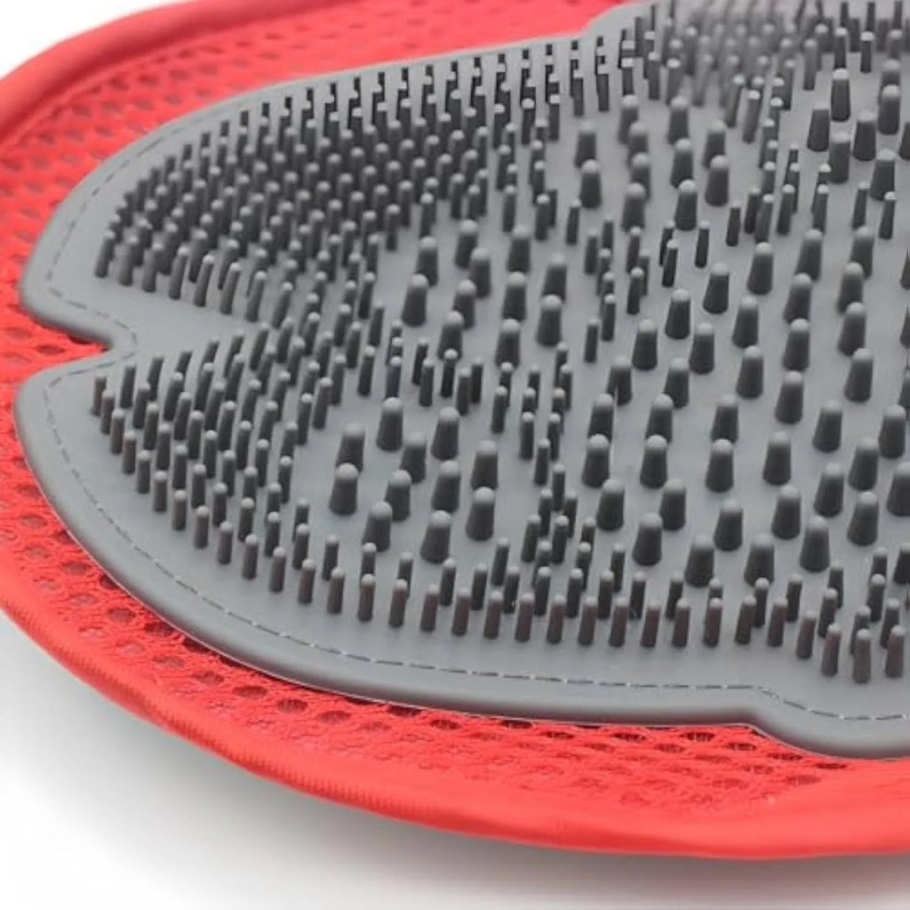 Red pet bathing glove with integrated brush for dog and cat grooming during washing.