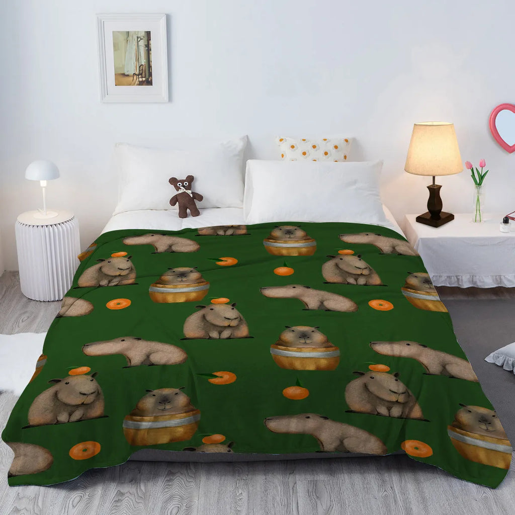 Flannel fleece blanket with orange capybara print, soft fluffy throw in three sizes with hemmed edges.