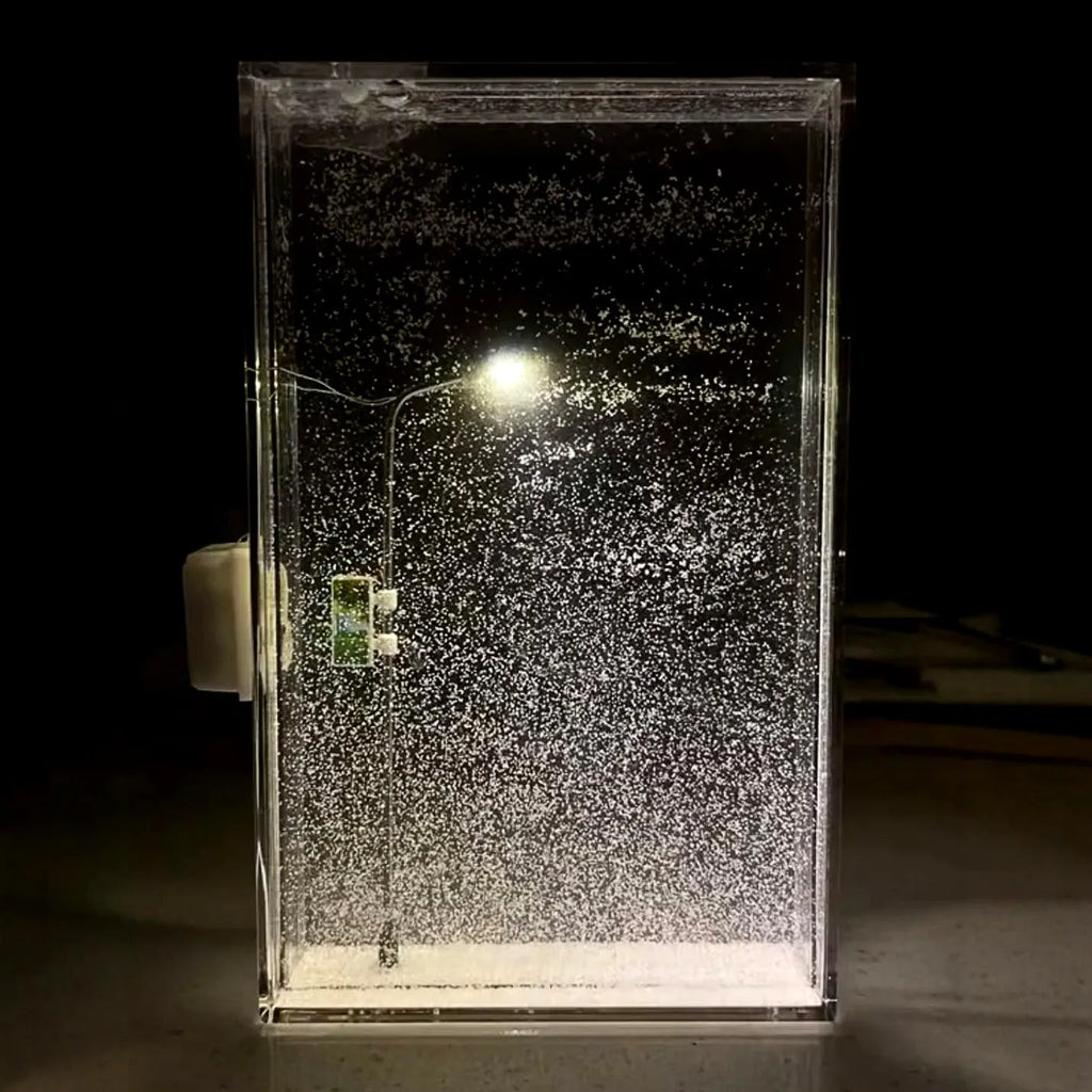 DIY snowy night light kit showing miniature street light and landscape with warm LED glow