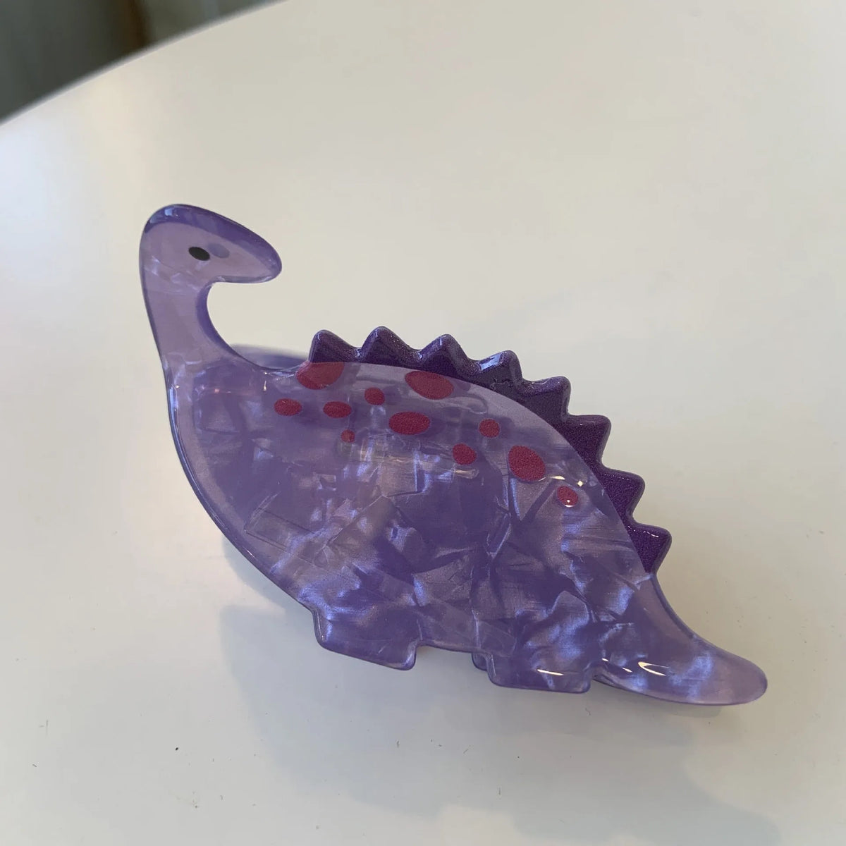 Acrylic dinosaur jaw hair clip showing six colour options including Pink Pterosaur and Blue Little Dinosaur designs