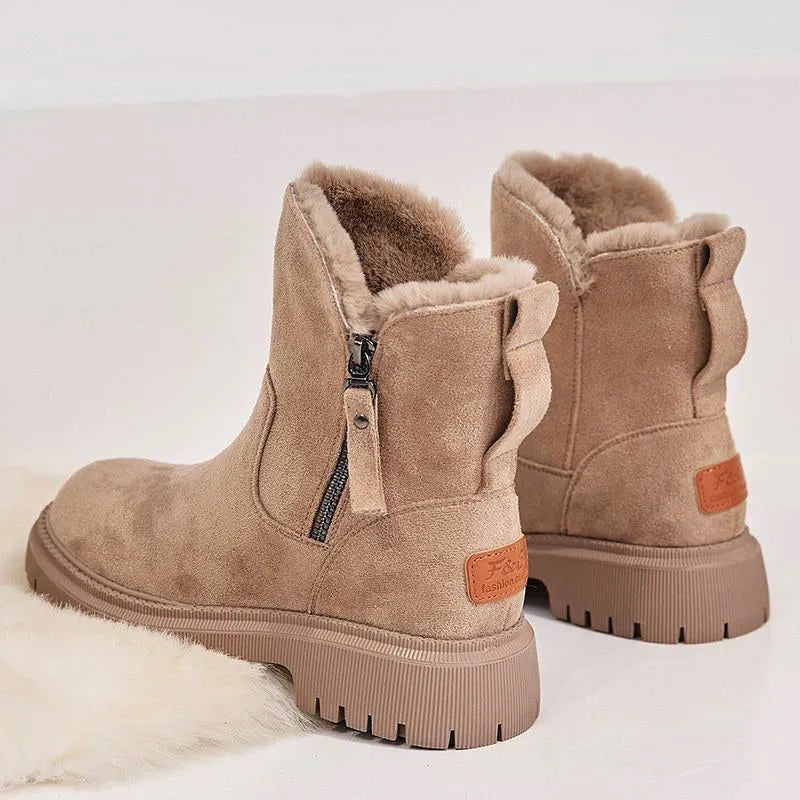 Women's black faux suede high-top snow boots with side zipper and faux fur lining.