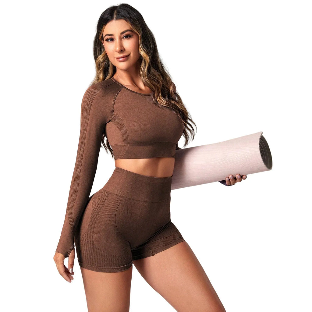 Women's black yoga suit set showing long sleeve pullover top and high-waisted tight-fitting pants.