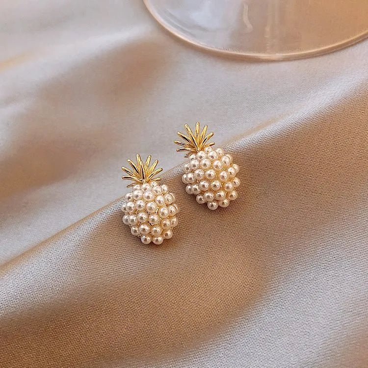 Gold colour Korean-style drop earrings featuring a pineapple and starfish design with pearl and gemstone inlay.