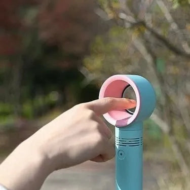 Compact portable bladeless fan in chosen colour on its base, with USB cable for charging.