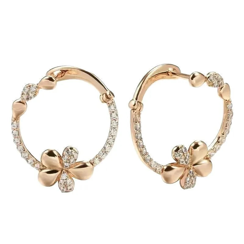 A pair of silver-colour round ring earrings for women on a white background.