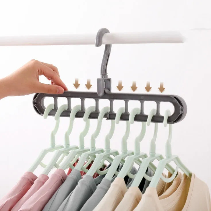 Pink or green heavy-duty plastic clothes hanger with rotating hook, shown holding a coat.
