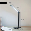 Wireless charging LED desk lamp with foldable design and USB port, shown in black.
