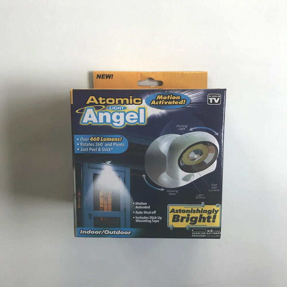 White Atomic Angel induction light unit on a surface, showing its compact 13.3cm by 9.8cm by 15.8cm dimensions.