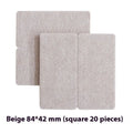 Assortment of beige plastic furniture leg protection pads in round and square sizes on wooden floor