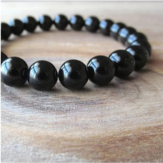 Geometric black onyx bead bracelet for women with elastic cord.