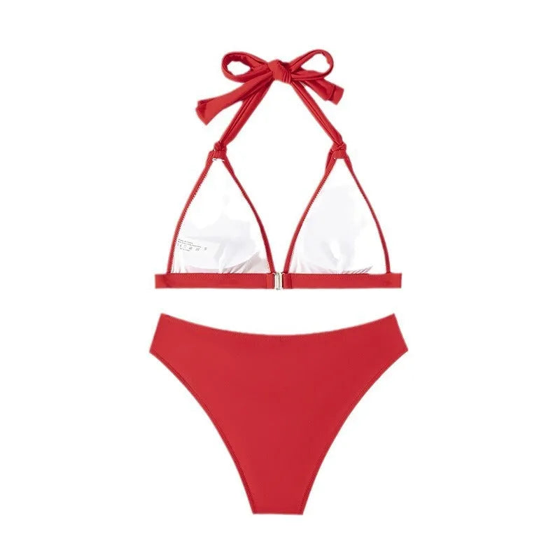 Red women's lace-up halterneck bikini set with split shorts on a mannequin.