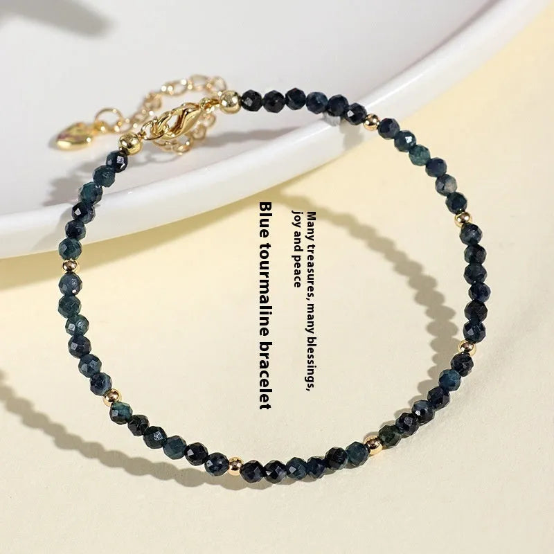 Blue tourmaline bracelet with 3mm cut beads and spacer bead design