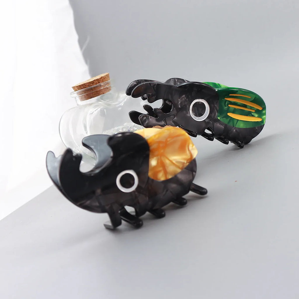 Handmade cellulose acetate Beetle Grip insect biology teaching tool with cartoon caterpillar design
