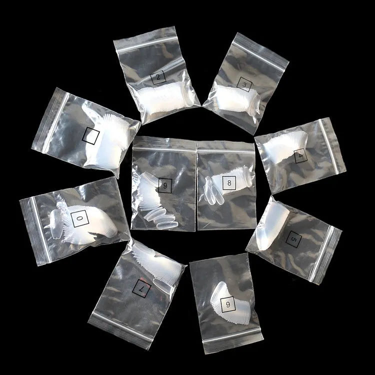 500 transparent false nails in various sizes on a white background, showing clear and natural colour options.