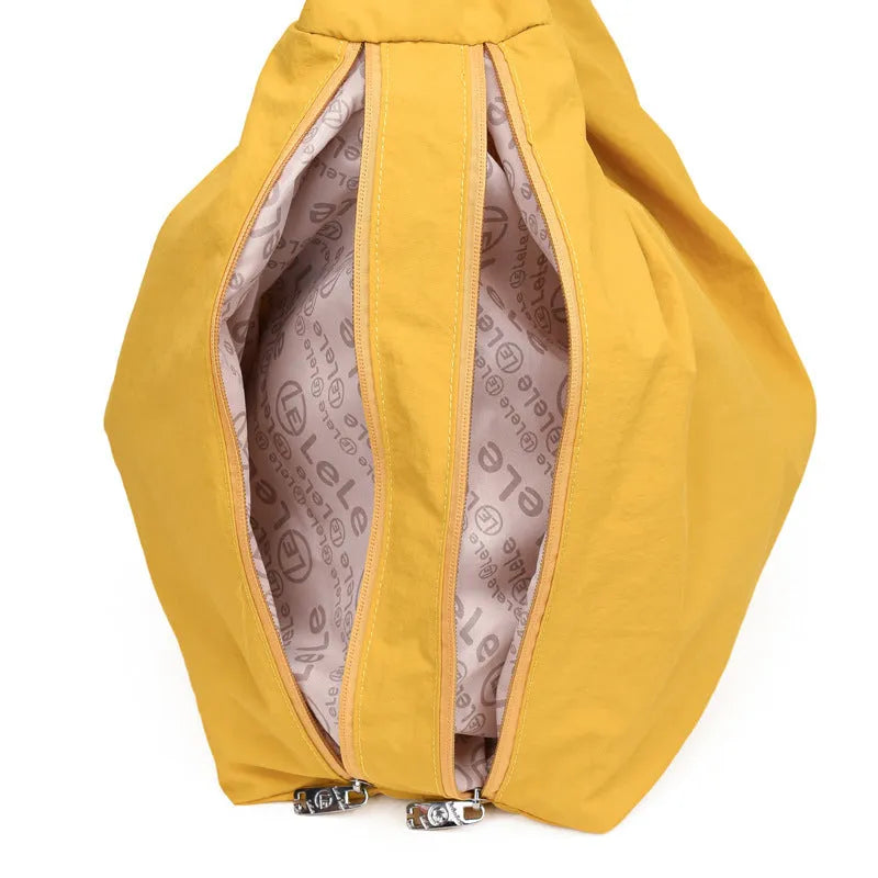 Women's heart-shaped nylon underarm bag in black, shown worn crossbody