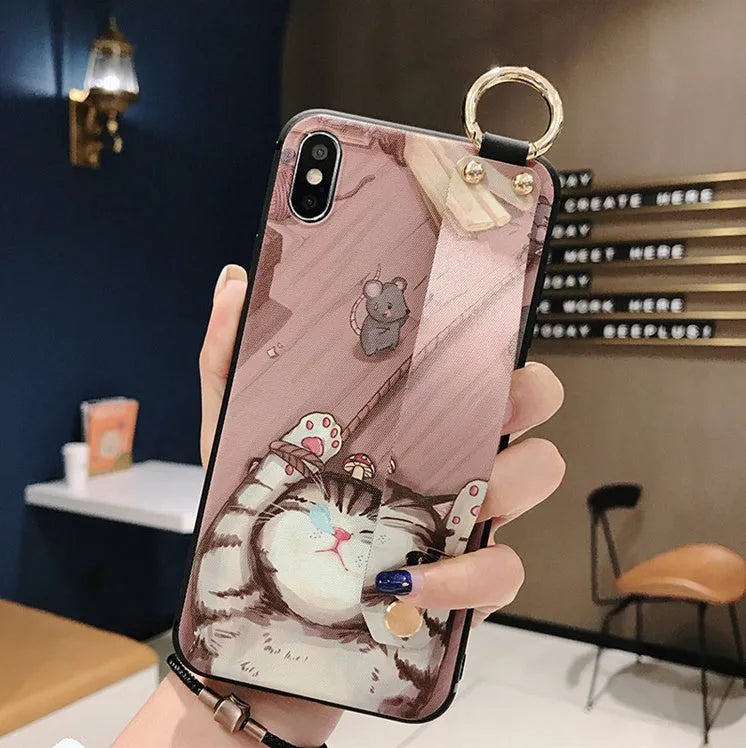 Rose flower design wrist strap case for Apple iPhone on a table.