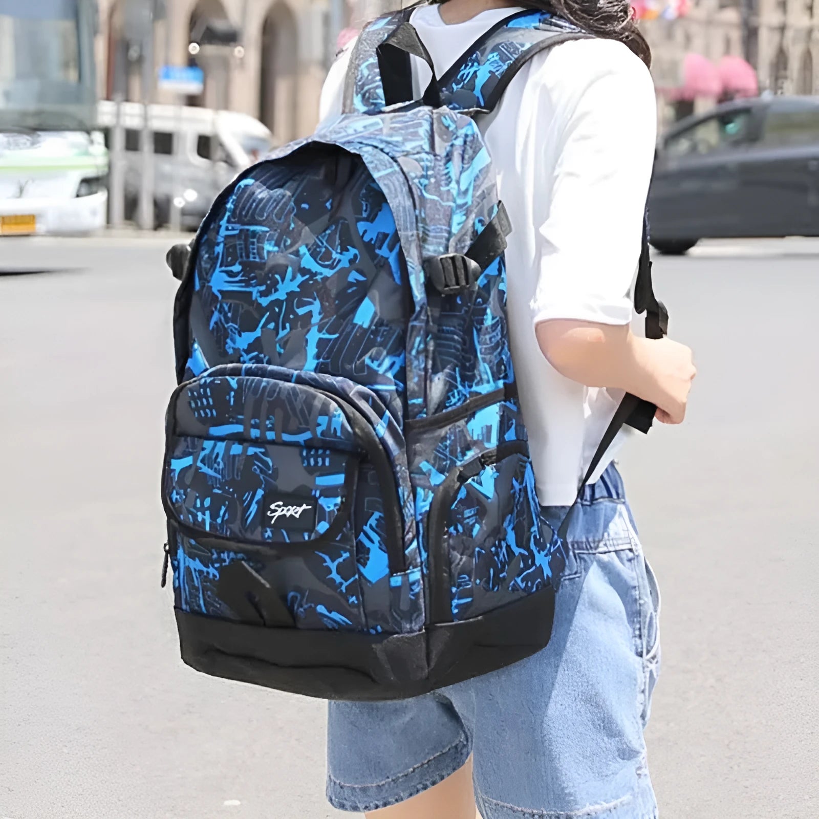 Blue classic nylon backpack with multiple compartments shown on a white background.