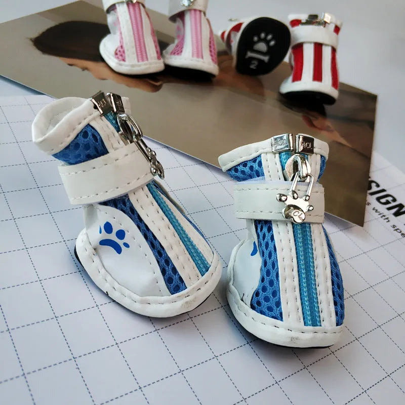 Four blue cloth dog shoes for small dogs with zipper closures on a white background.