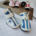 Four blue cloth dog shoes for small dogs with zipper closures on a white background.