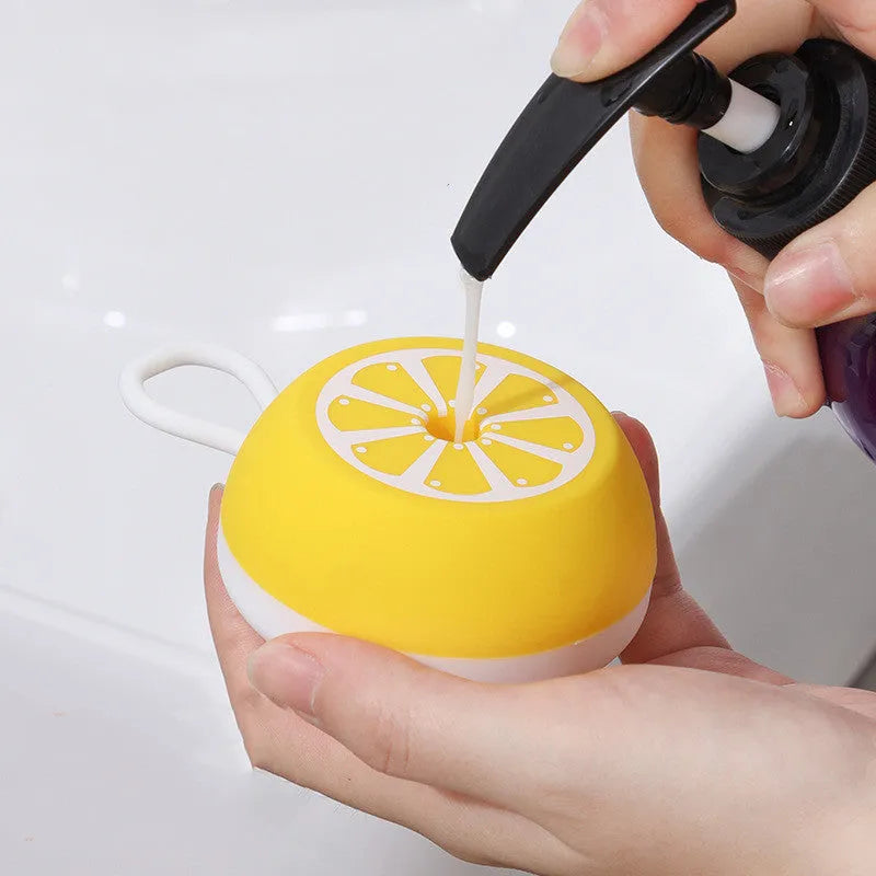Yellow silicone pet bath brush with massage nodes and comb teeth for dog and cat grooming during washing
