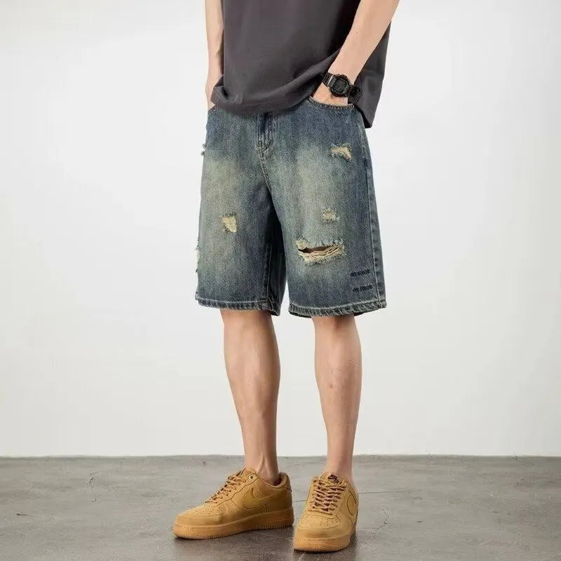 Blue retro loose hole men's denim shorts with a straight cut, shown on a model.