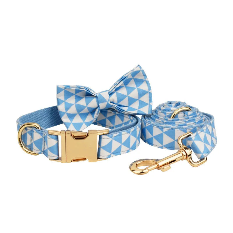 Blue cloth dog collar, leash, vest, and decorative bow four-piece pet accessory set.
