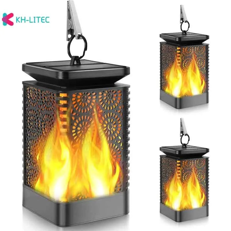 Four black solar-powered hanging torch lights with flickering flame LED effect for outdoor gardens.
