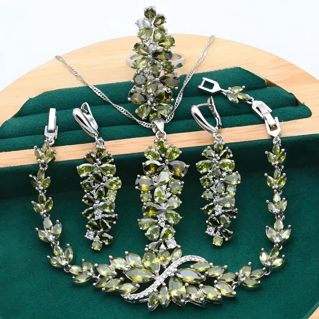 Retro style jewellery set showing necklace with floral pendant, bracelet, earrings, and ring in olive and purple colours.