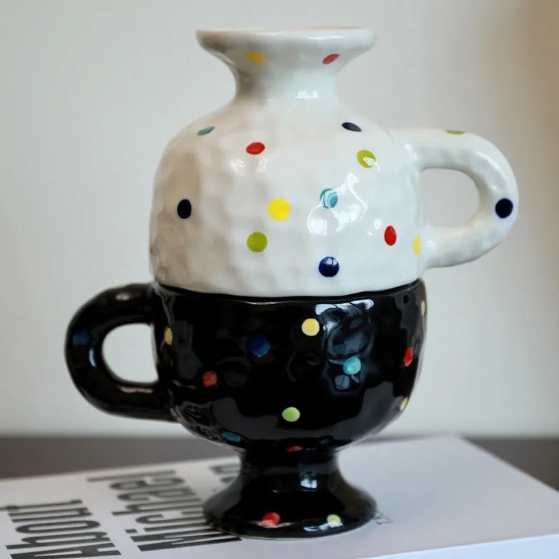 Irregular shaped hand-pinched ceramic mug in solid colour showing unique contours and modern design