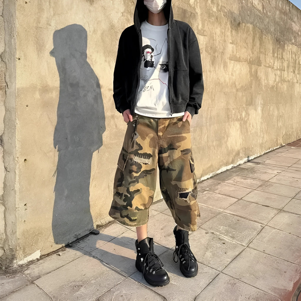 Men's camouflage coloured cropped jeans with ripped detailing and retro patch accents
