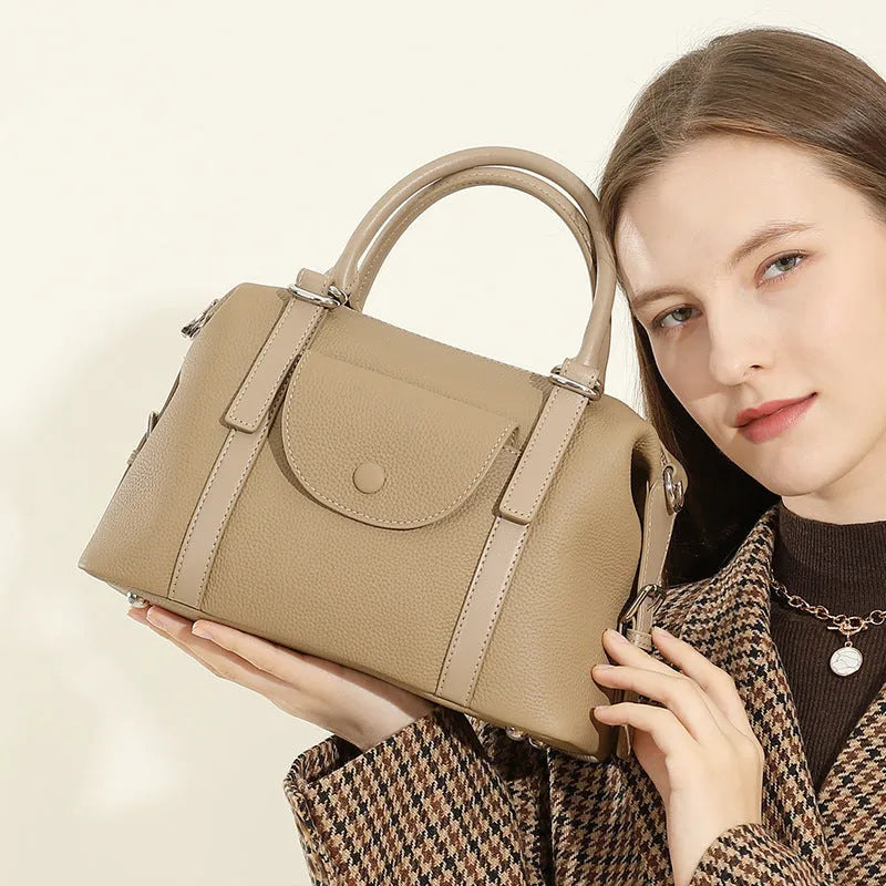 Genuine leather street style handbag for women with adjustable shoulder strap.