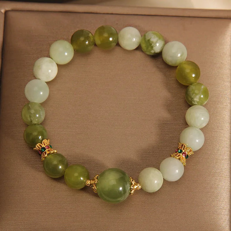 Women's jade bracelet in Xiuyan jade green colour with original design on wrist.