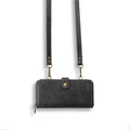 Black detachable magnetic wallet phone case for iPhone and Samsung Galaxy Note on a table.