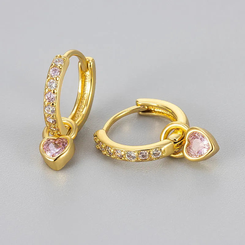 Women's gold-coloured heart drop earrings with a blue zircon stone centre and clip-on fastening.
