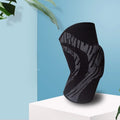 Men's pressurised basketball knee pads in black with compression support around kneecap