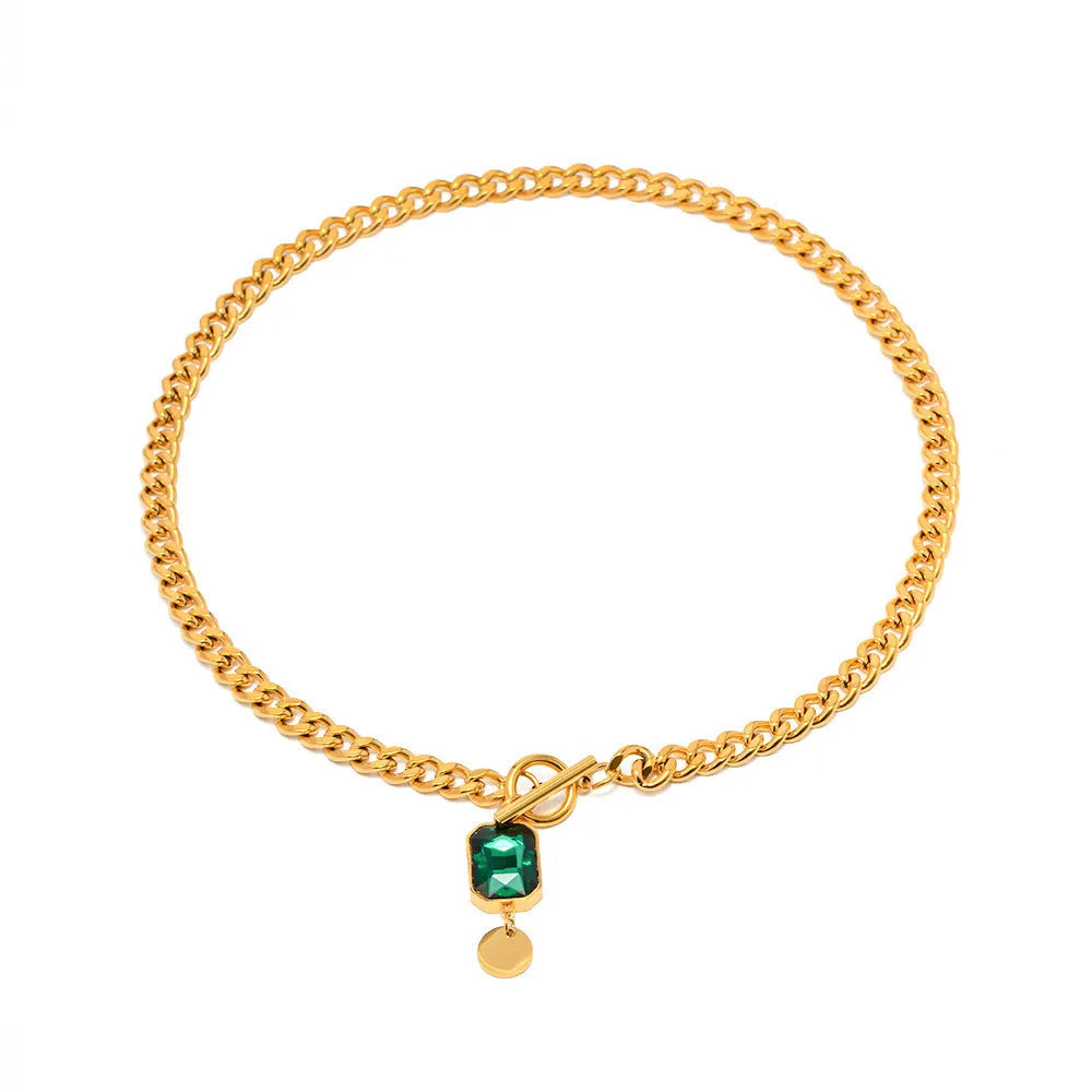 Gold electroplated titanium steel necklace with geometric pendant and emerald zircon stone on Cuban link chain