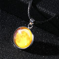 Christmas moon and night sky luminous constellation pendant on a glass necklace chain.