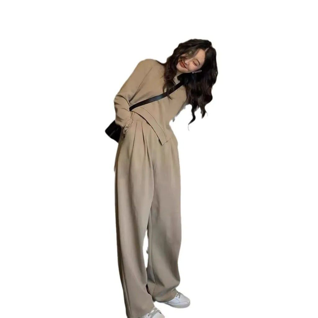 Women's brown loose-fit casual sports suit with long sleeves and full-length trousers on a hanger.