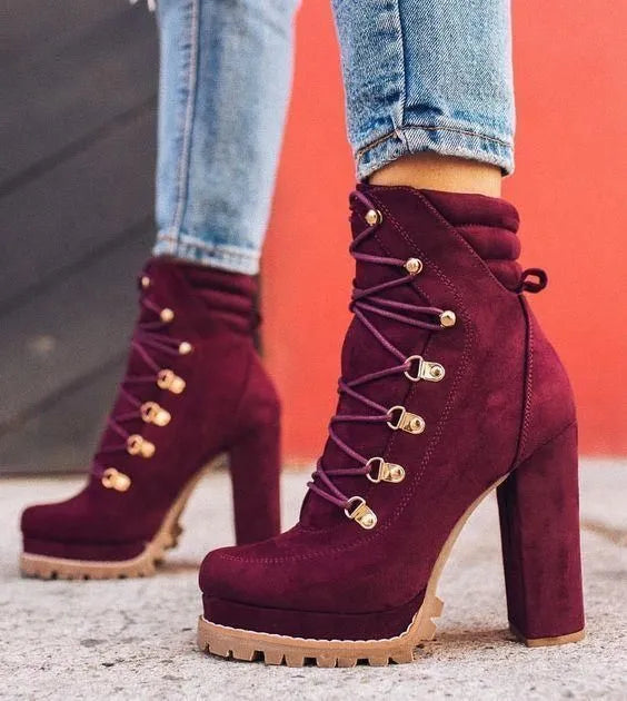 Women's army green suede high-heel boots with round toe, thick heel, belt buckle, and rivet details.