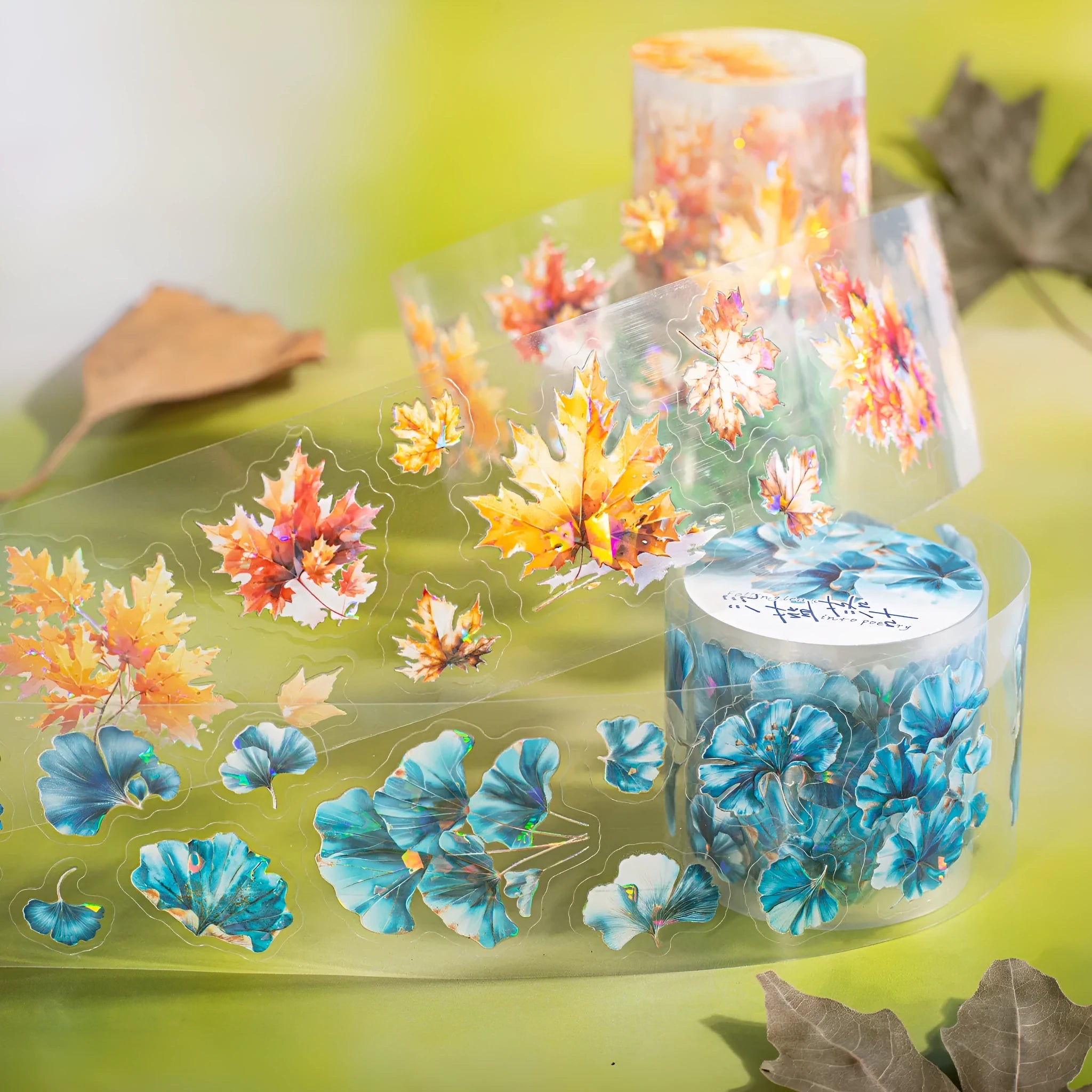 Roll of clear PET decorative stickers with repeating leaf patterns including ginkgo and maple designs.
