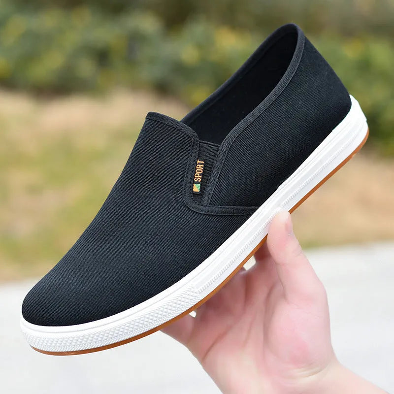 Men's black low-top canvas slip-on shoes with round toe and composite sole