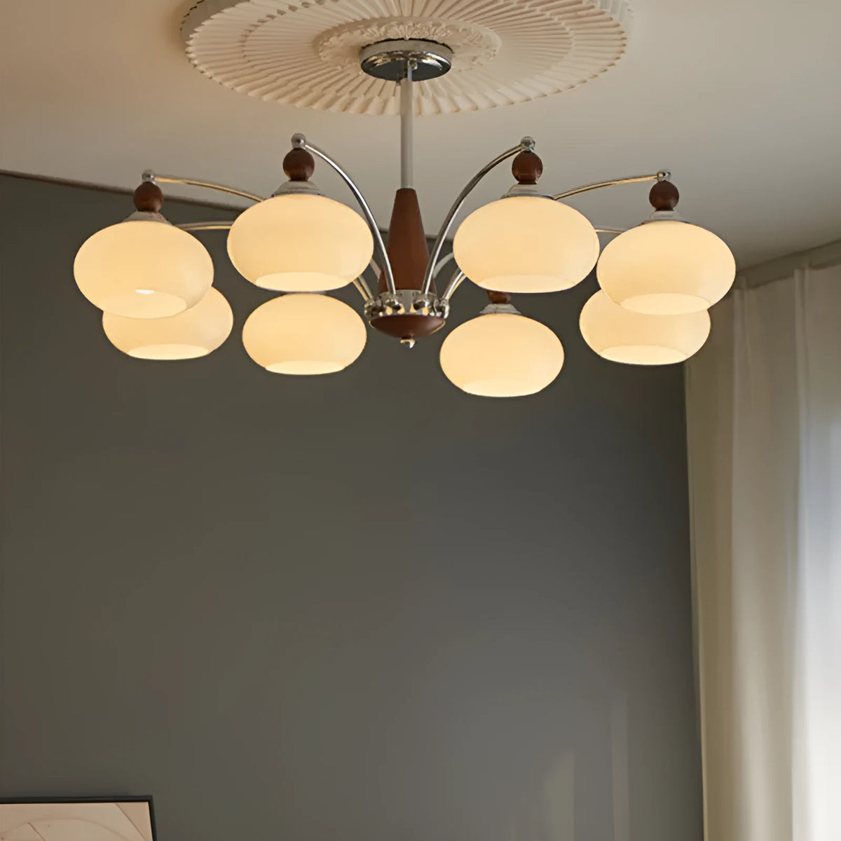 Chrome and persimmon glass chandelier ceiling light with multiple bulbs for dining room.