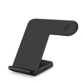 Black and white Qi wireless phone charger with Type-C cable on a desk