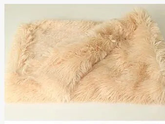 Soft long plush dog blanket in dark grey, sizes S M L shown next to a large dog.