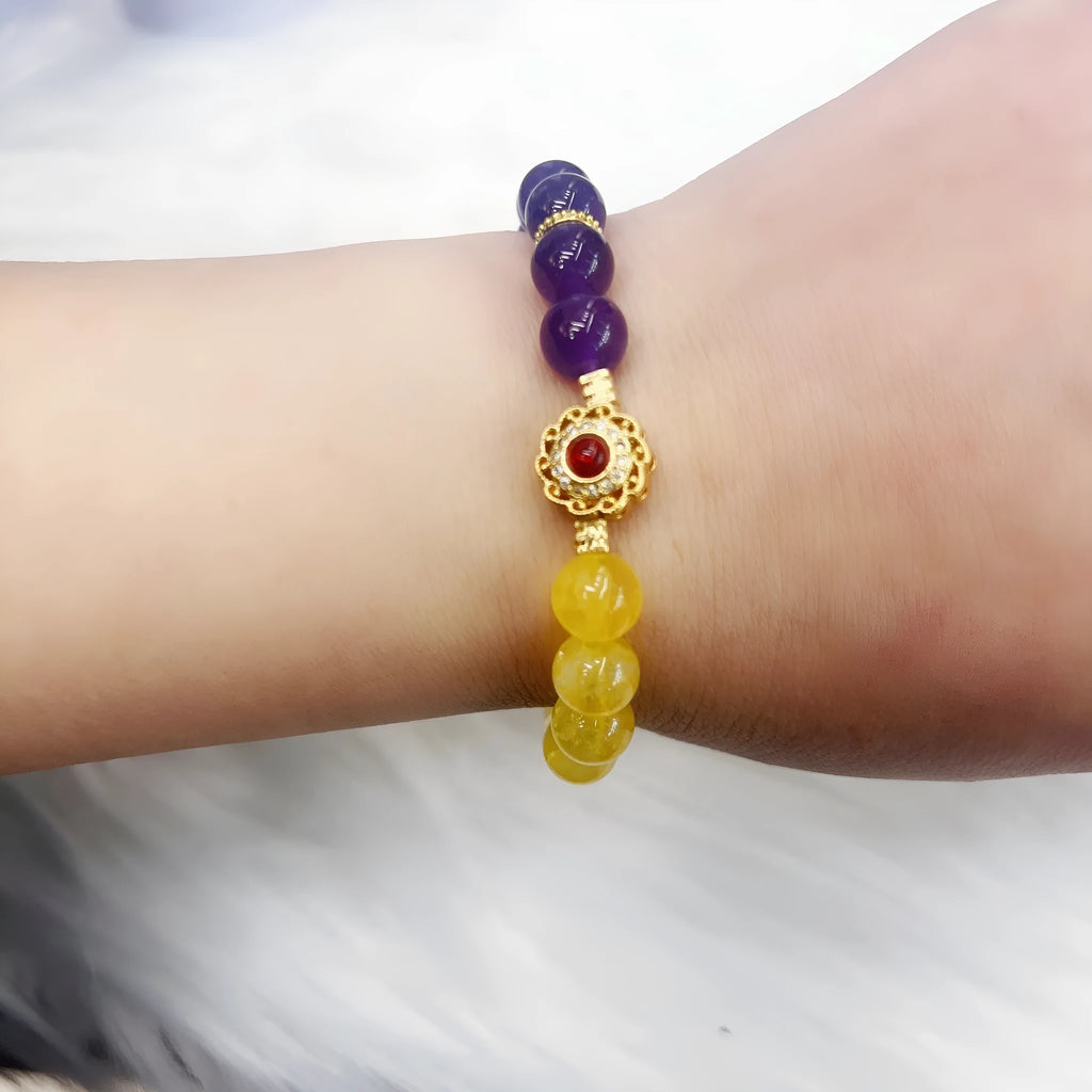 Handmade women's yellow and purple crystal bracelet with amethyst beads on wrist