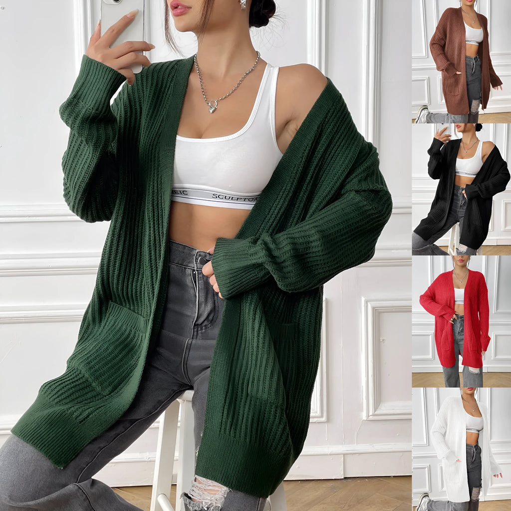 A women's loose dark green cardigan sweater with two pockets and long sleeves.