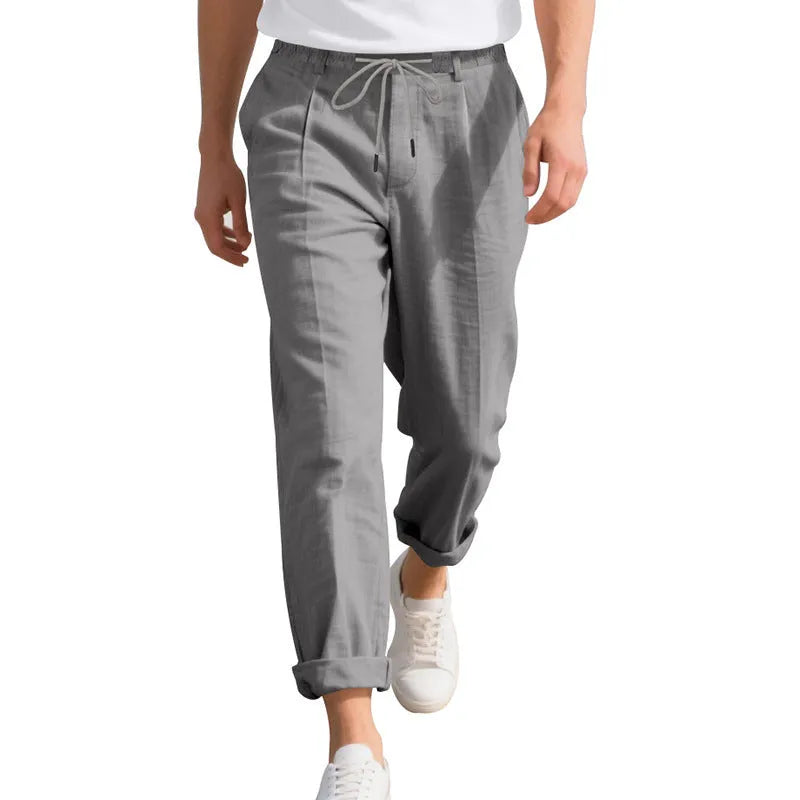 Men's casual linen trousers in a straight leg cut with a drawstring waist, shown in a light colour.