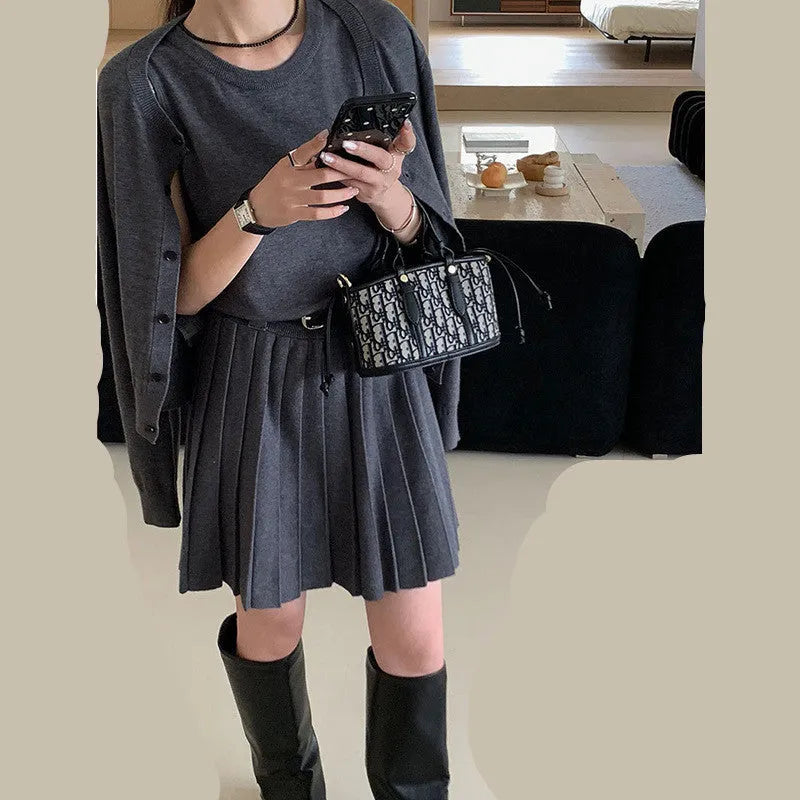 Women's art retro knitted two-piece set featuring a pleated vest skirt with 3D pattern and a long-sleeved cardigan.